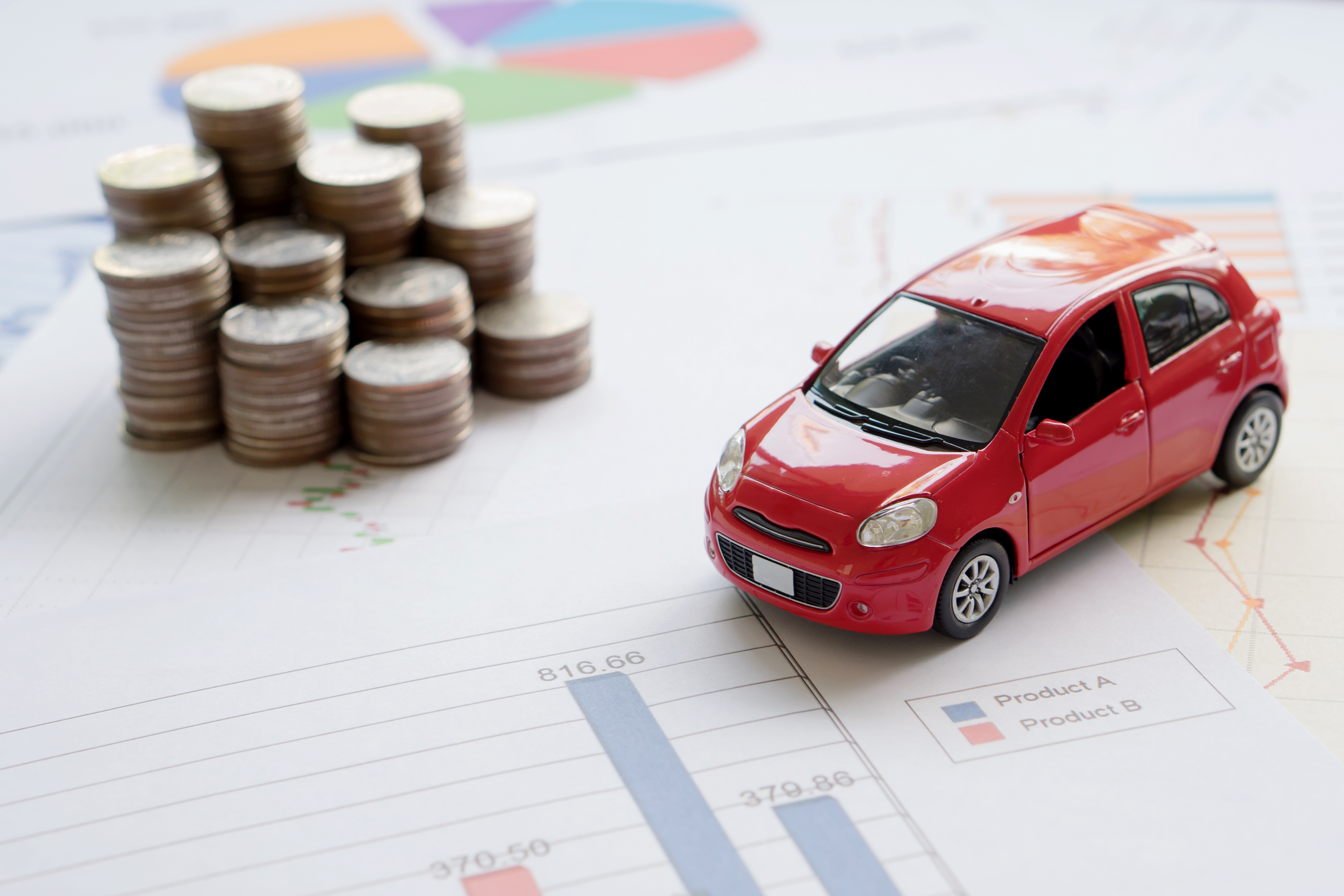 Car model and Financial statement with coins. (finance and car loan concept)
